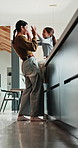 Mother, child and happy with high five in home for growth milestone, family bonding or support. Mature woman, kid and celebration in kitchen for development praise, healthy relationship or connection