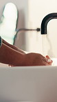 Water, bathroom and person washing hands in home for health, self care or wellness by sink. Sanitize, disinfection and cleaning skin for removal of bacteria, germs or dirt for hygiene in house
