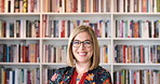University, face or professor in library with smile, ambition or pride in academic position. Happy, woman or lecturer on college campus with literature, confidence or about us in education industry.