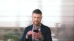 Businessman, scroll and text message in office with phone, email and website for project management. Space, mature person and check notification with tech, mobile app or reading company communication