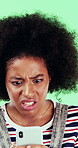 Black woman, phone and stress for texting in studio for post, scam or fake news on green background. African girl, thinking and frustrated on mobile app, confused or worry for hacking on social media