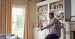 Dance, excited and black man in living room with energy for celebration, performance and expression. Back, movement and male person with hip hop for hobby, entertainment and weekend fun in home