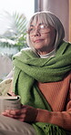 Thinking, old woman and relax with book in lounge, smile and skill development with puzzle or learn. Elderly person, reflection and playing word game with info, retirement and hobby on break in house