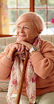 Thinking, smile and old woman with cane on sofa for happy memory, reflection and nostalgia. Nursing home, relax and elderly person with cane for wondering, wellness and remember with walking stick