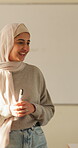 Education, teacher and Muslim woman in classroom for lesson, knowledge and discussion with students. School, educator and person with hijab, talk and teaching learners with smile and explanation