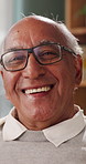 Face, glasses and senior man in home with smile, retirement wellness and laughing for weekend break. Portrait, eyewear and elderly person with happiness for funny joke, relax and humor in apartment