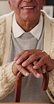 Hands, cane and elderly man in home for support, relax and happy for balance in retirement. Walking stick, senior person with disability and smile in house with mobility aid, wellness and self care