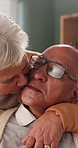Hug, kiss and old couple in living room with love, connection and bonding together for retirement. Happy, elderly people talk and embrace in home with marriage commitment, affection and relationship.
