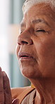 Prayer, religion or senior woman in home for hope, worship or spiritual connection with Jesus Christ. Faith, elderly person and praying to God for forgiveness, holy guidance and devotion at house