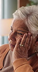 Retirement, sadness and thinking with senior woman in home living room for reflection or nostalgia. Memories, perspective and regret with old person in apartment for contemplation, ideas or remember