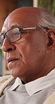 Nostalgia, retirement and thinking with senior man in home living room for reflection or regret. Contemplation, memories and old person with depression in apartment for ideas, remember or sadness