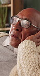 Memories, sadness and thinking with senior man in home living room for reflection or nostalgia. Perspective, regret and retirement with old person in apartment for contemplation, ideas or remember