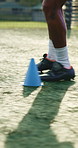 Legs, person and drill with cone for soccer, fitness or practice for running guide or exercise. Athlete, beacon and warm up challenge with football, agility and performance for game training on field