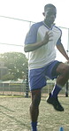 Jump, person and sport with cone for soccer, fitness or practice for running guide and exercise. Athlete, beacon and warm up challenge with football, agility or performance for game training on field