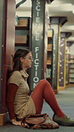 Library, tired woman and sad student with stress, exam fail or education pressure in college. Burnout, university or person with depression on floor for bad grades, assignment deadline or overwhelmed