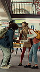 Students, laugh and hands together in college with motivation, education goals or success for learning. Friends, people stack and smile at university library with encouragement, growth and knowledge.