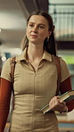 Woman, student and walking in library with textbook for learning, education or study material. Person, academic scholar or learner with project, novel and knowledge for thesis research at university