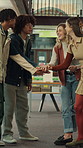Happy, students and hands together in college with motivation, education goals or success for learning. Friends, people stack and smile at university library with encouragement, growth and knowledge.