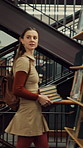 Woman, student or walking with books in library for education, knowledge or learning in university. Female person, academic or learner with smile, textbooks or aisle for study material or information