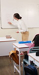Writing, teaching and woman in classroom with whiteboard for creative education, lesson or learning. Happy, teacher or educator in school with questions, solution and development for knowledge