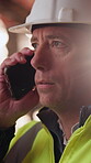 Logistics, phone call and man with helmet in warehouse, communication or delivery update for contact. Factory, project manager and mature person with mobile for chat, supply chain and distribution