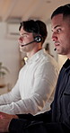 Talking, people and man with headset in call center, troubleshooting advice and customer care at night. Tech support, late hotline or agent with explanation for solution, contact or online help desk