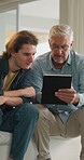 Mature, father and adult son with tablet, bonding together and help to search online news on weekend. Dad, man and conversation in home with tech, support and assistance for browsing digital article.