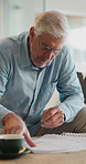 Mature, man and reading in home with documents, financial planning or coffee steam on weekend break. Person, check paperwork and warm drink in living room with finance budget, bills or review invoice