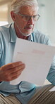 Stress, paperwork and old man in home with worry, confused or reading letter of debt. Insurance, mistake and senior person thinking with pension documents, bankruptcy notice or retirement plan