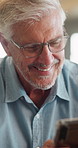 Mature, man and laugh in home with phone, social media meme and thinking for funny joke on weekend. Happy, person reading and reflection in house with tech, glasses and mobile app for internet humor.