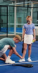 Padel, sports and children tie shoes in indoor court for training, exercise and practice together. Tennis, siblings and boy help girl with shoelace ready for game, competition and fitness for match
