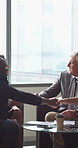 Group, handshake and smile in business meeting, discussion and planning for financial growth or deal. People, shaking hands and collaboration with paperwork, investment and agreement with gesture