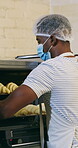 Croissant, oven and man with mask in bakery, small business or baker with culinary skills in kitchen. Catering, hygiene and safety with ppe in restaurant, food production and person with pastry order