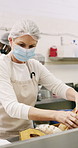 Woman, bakery and rolls with box in factory for catering service or small business distribution. Female person, pastry chef or packing crate with bread for food production, baking or culinary art
