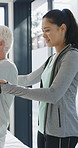 Physiotherapy, woman and help with senior man for injury recovery, fitness and rehabilitation. Physical therapy, chiropractor and elderly patient with exercise, healing and smile in healthcare clinic