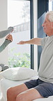 Physiotherapist, advice or old man in clinic with stretching, rehabilitation or mobility for wellness. Senior person, physical therapy and talk in consultation with fitness, injury recovery and help.