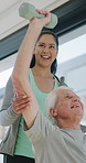 Physiotherapy, support and elderly man with dumbbells, help and exercise for muscle recovery. Physical therapy, woman or senior patient weightlifting to improve strength, smile or healthcare clinic
