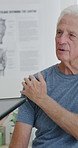 Physiotherapist, tablet or senior man in clinic with shoulder pain, explain symptoms or rehabilitation. Elderly person, healthcare worker and talk with tech, patient wellness survey or injury update.