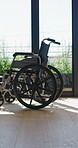 Wheelchair, sunlight and window in hospital facility for disability, impairment or retirement home. Mobility, space and chair at rehabilitation center for healthcare, recovery and assisted living