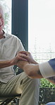 Elderly man, caregiver and holding hands with support for wheelchair, comfort or trust in retirement home. Smile, nurse and person with a disability for help, rehabilitation and senior care in house