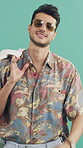 Face, fashion and sunglasses with happy man in studio for holiday apparel or summer aesthetic. Clothing, shades and smile with confident person on green background for getaway, travel or vacation