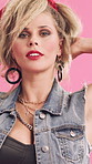 Face, fashion and edgy woman in studio with accessories, cool and funky style on pink background. Retro, reveal, confident person with punk and rock jewelry, hair and makeup for 80s aesthetic