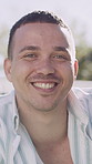 Face, confident and man with smile outdoor for travel trip, adventure and holiday abroad. Portrait, male person and nature with happiness, positive attitude and vacation overseas for weekend getaway