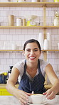 Happy woman, face or barista serving with coffee in cafe for hospitality or catering. Portrait, female person or espresso artist with smile, latte or cappuccino cup on counter for customer service