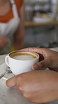 Serving, woman and barista with customer for coffee for order, service or hospitality job. Happy, latte and female waitress with person for cup of warm beverage with purchase in restaurant or diner.