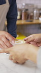 Man, barista and hands with coffee for customer service, latte or cappuccino in cafe. Male person, espresso artist or waiter with cup of caffeine for client order, hospitality or catering in shop