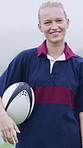 Face, rugby ball and woman outdoor for training, sports game and confidence on pitch with fog. Portrait, happy player and female athlete at field for exercise, practice and smile with fitness