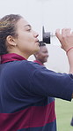 Woman, team and drinking water at college with sports practice, sweat or training break for recovery. Thirsty, person and hydration on field outdoor with university rugby group, exercise or wellness.