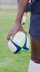 Rugby, field and ball in hand for competition, match fixture and ready for tournament at stadium. Person, sports contestant and outdoor with football for challenge, training and team player in game