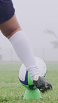 Rugby ball, foot and player on field with kick, start game or winter match in competition. Sport, person and football on tee for challenge, score conversion or accuracy practice with fitness on grass
